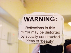 Reflections in mirror may be distorted by socially constructed ideas of beauty